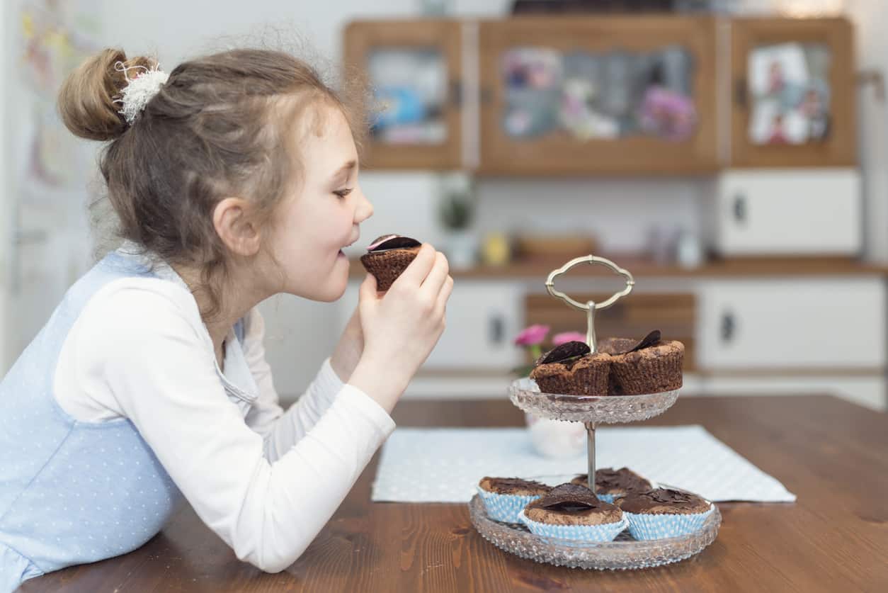 little girl eating cupcakes So Yummy